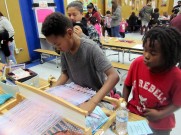 Student learns about loom weaving